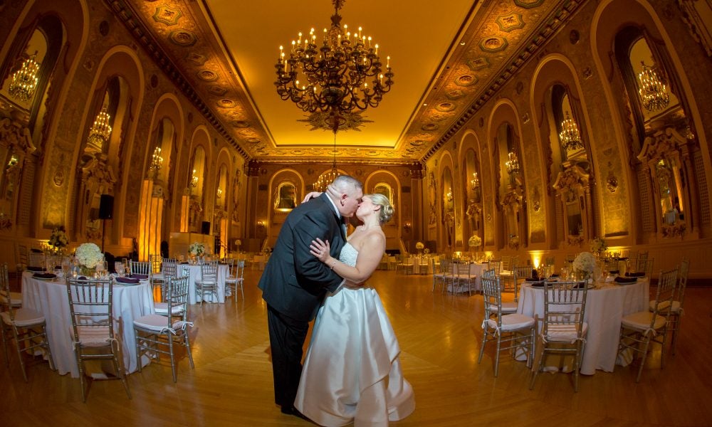Samantha and Joseph, bride and groom kissing in ballroom