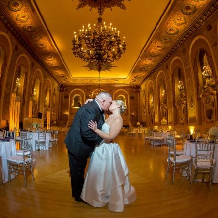 Samantha and Joseph, bride and groom kissing in ballroom