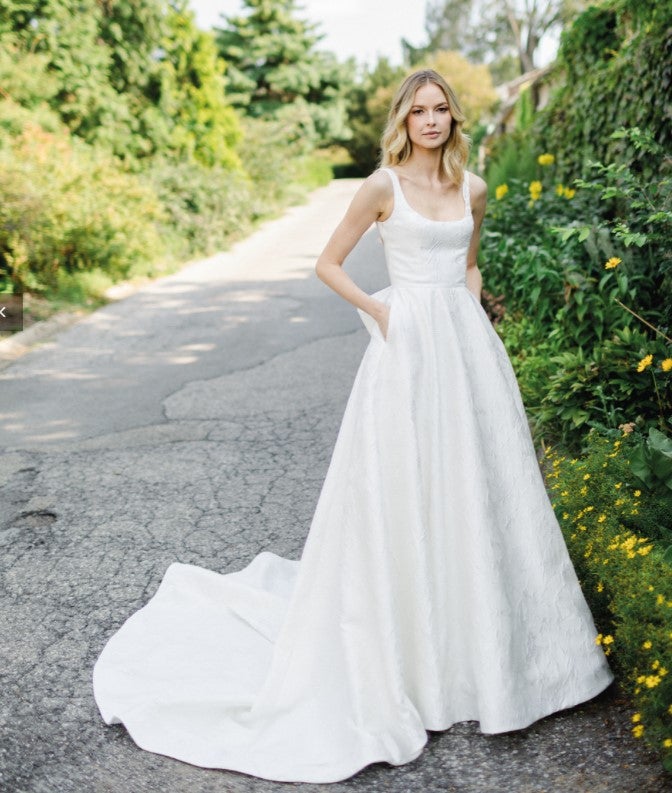 https://www.kleinfeldbridal.com/wp-content/uploads/2022/11/verdin-bridal-new-york-sleeveless-a-line-wedding-dress-with-open-back-and-bow-34608133.jpg