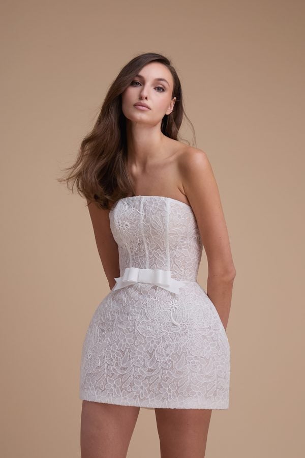 Chic And Romantic Lace Bridal Mini Dress With Bow by Jaclyn Whyte - Image 1