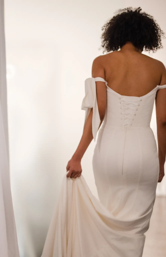 Plus-Size Minimalist Sheath Wedding Dress With Off-The-Shoulder Bows by Love by Pnina Tornai - Image 2